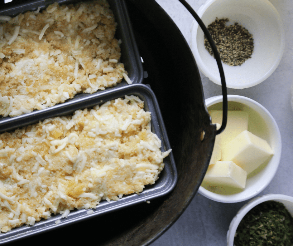 Add the pork rind crumbs, baking powder, garlic, cheese, sour cream, and three eggs to a bowl. Stir well.
